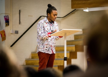 student reading aloud at lectern