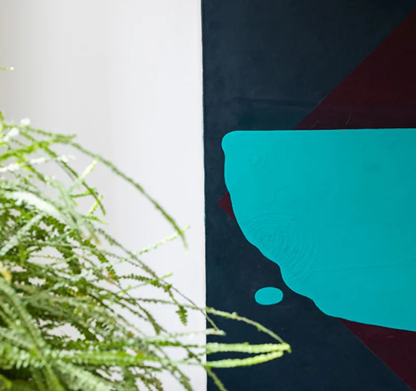 pot plant to the left of a piece of abstract art