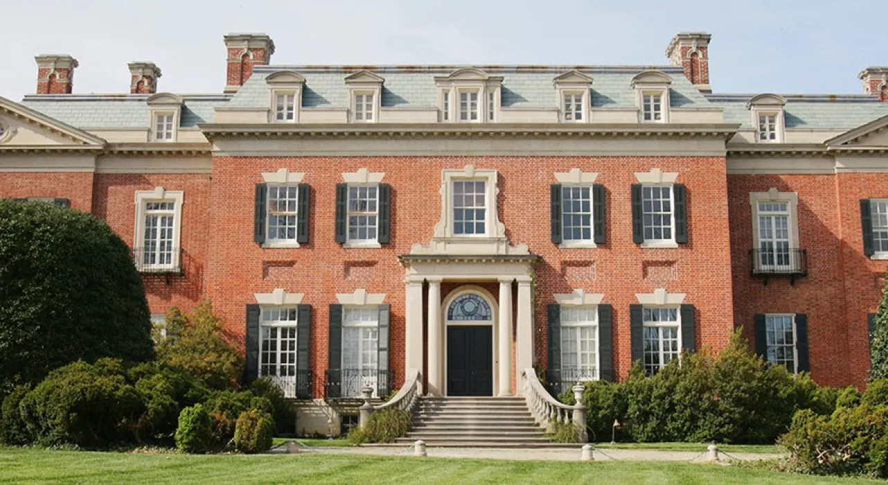grand redbrick building with extended wings and sweeping steps