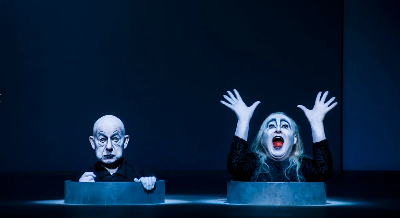two clowns appearing out of holes, one with hands raised and mouth open. photo credit Lovis Ostenrik
