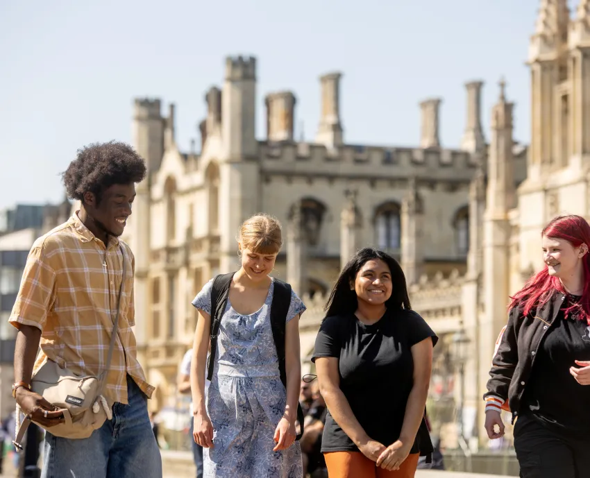 A group of University of Cambridge students are walking outside the King's College talking and laughing in the sunshine. Copyright: University of Cambridge (June 2024)