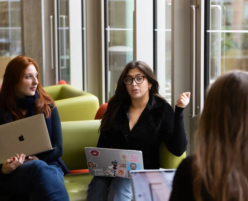 three people in small group discussion