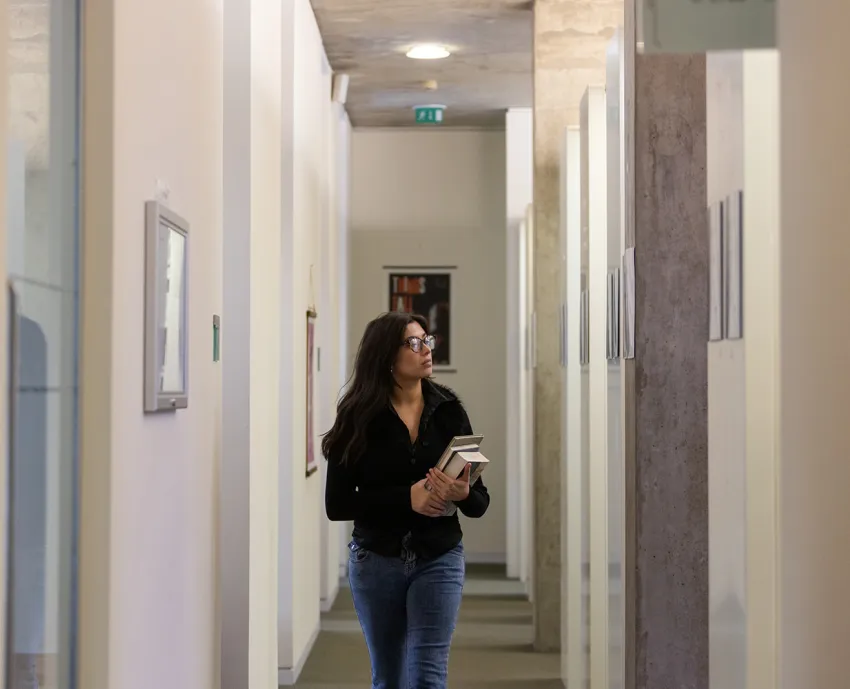 student walking down corridor looking around