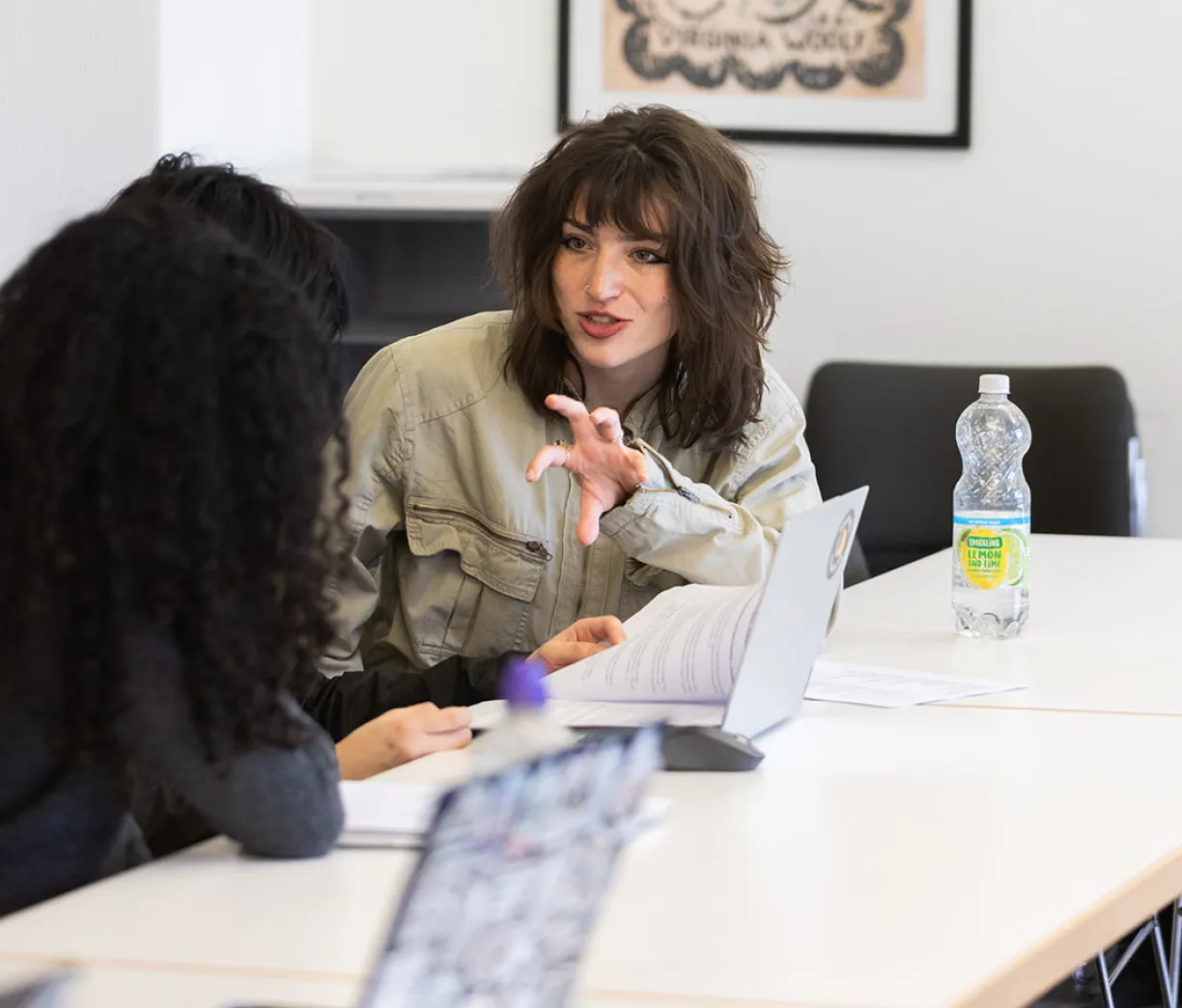 student talking animatedly to another