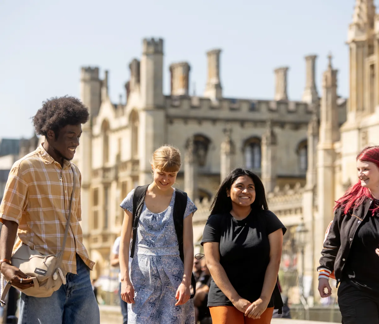 A group of University of Cambridge students are walking outside the King's College talking and laughing in the sunshine. Copyright: University of Cambridge (June 2024)