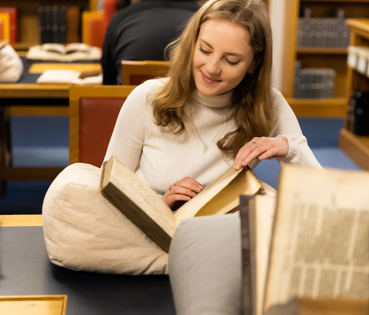 Woman reading a rare book
