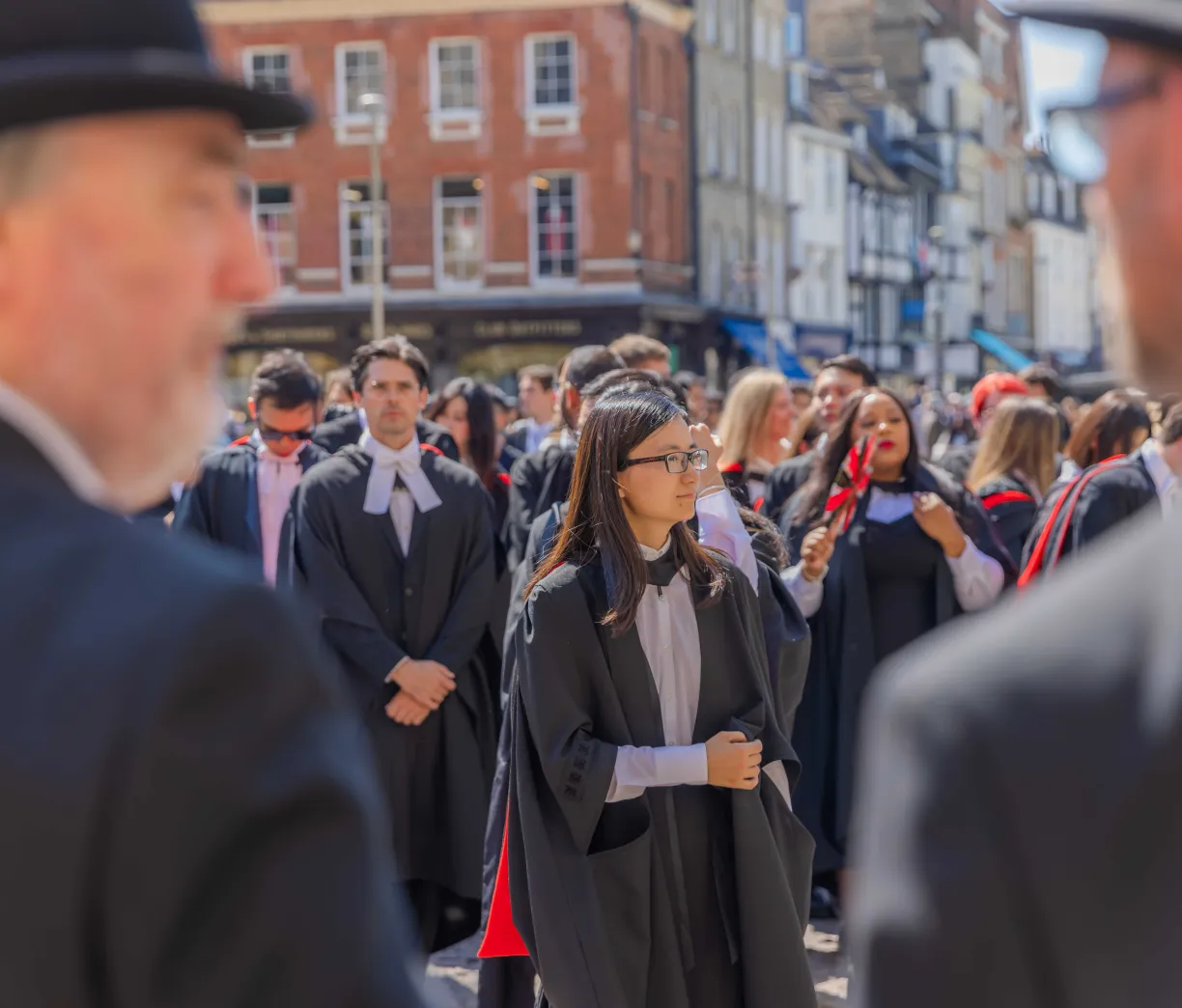The University of Cambridge students are standing on Senate House Hill in their gowns waiting for their graduation at the Senate House. Copyright: University of Cambridge (July 2024)