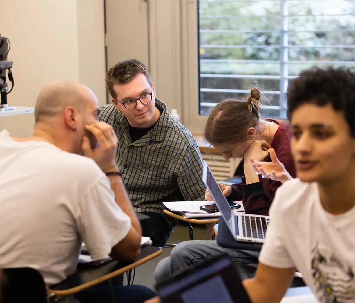 two clusters of students engaged in seminar discussion