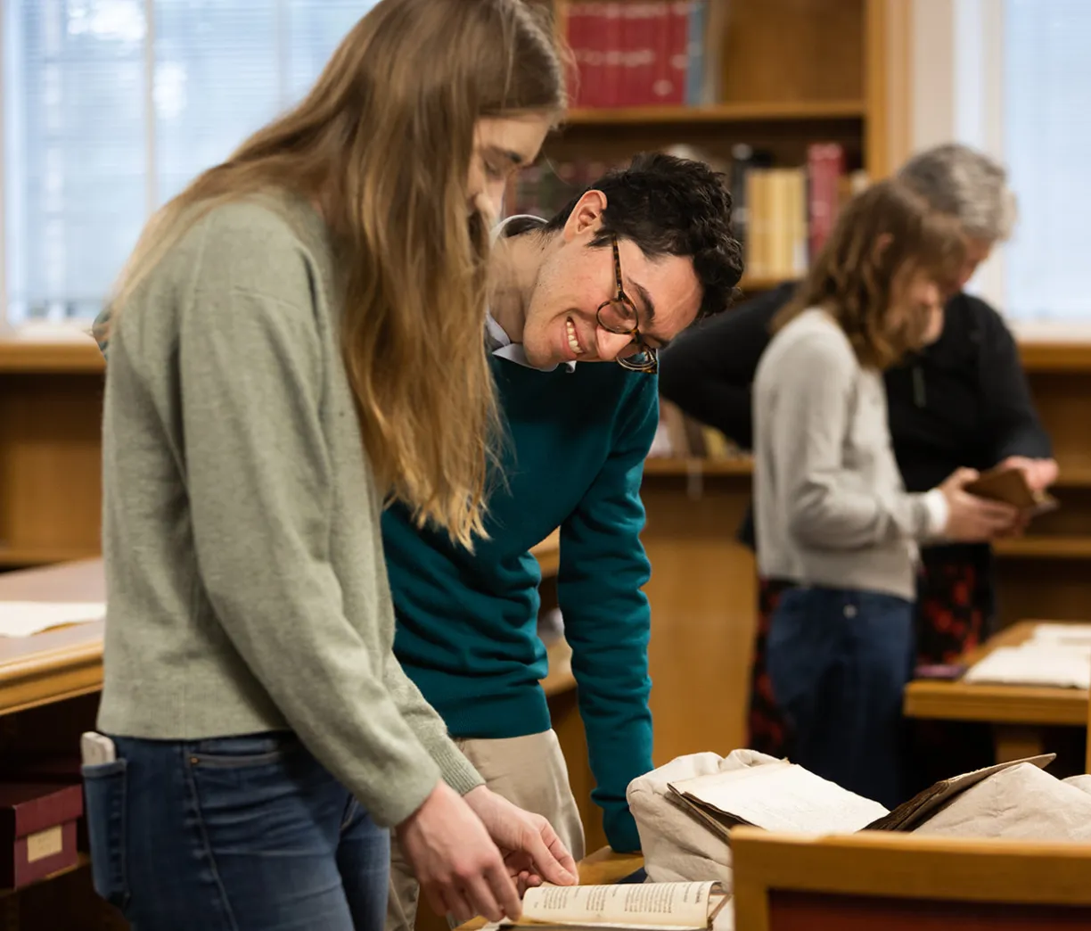 two scholars looking at a rare book